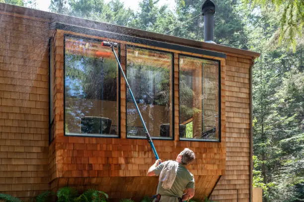 Camelot technician washing residential windows in Nashville, TN