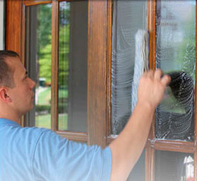 Camelot technician washing residential windows in Nashville, TN